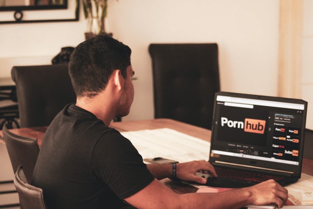 image of man watching porn with blurred screen